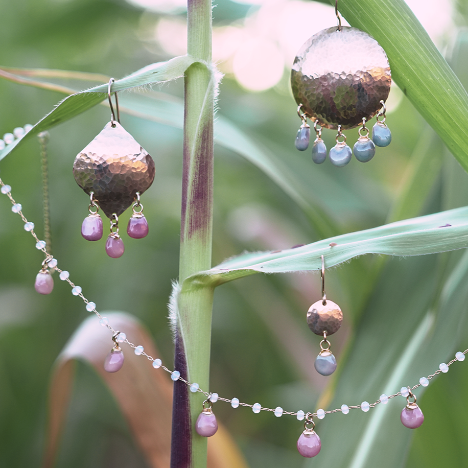 Glass Gem corn earrings and necklace hanging among corn leaves