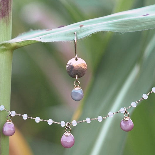 Glass Gem corn earrings and necklace hanging on a corn leaf