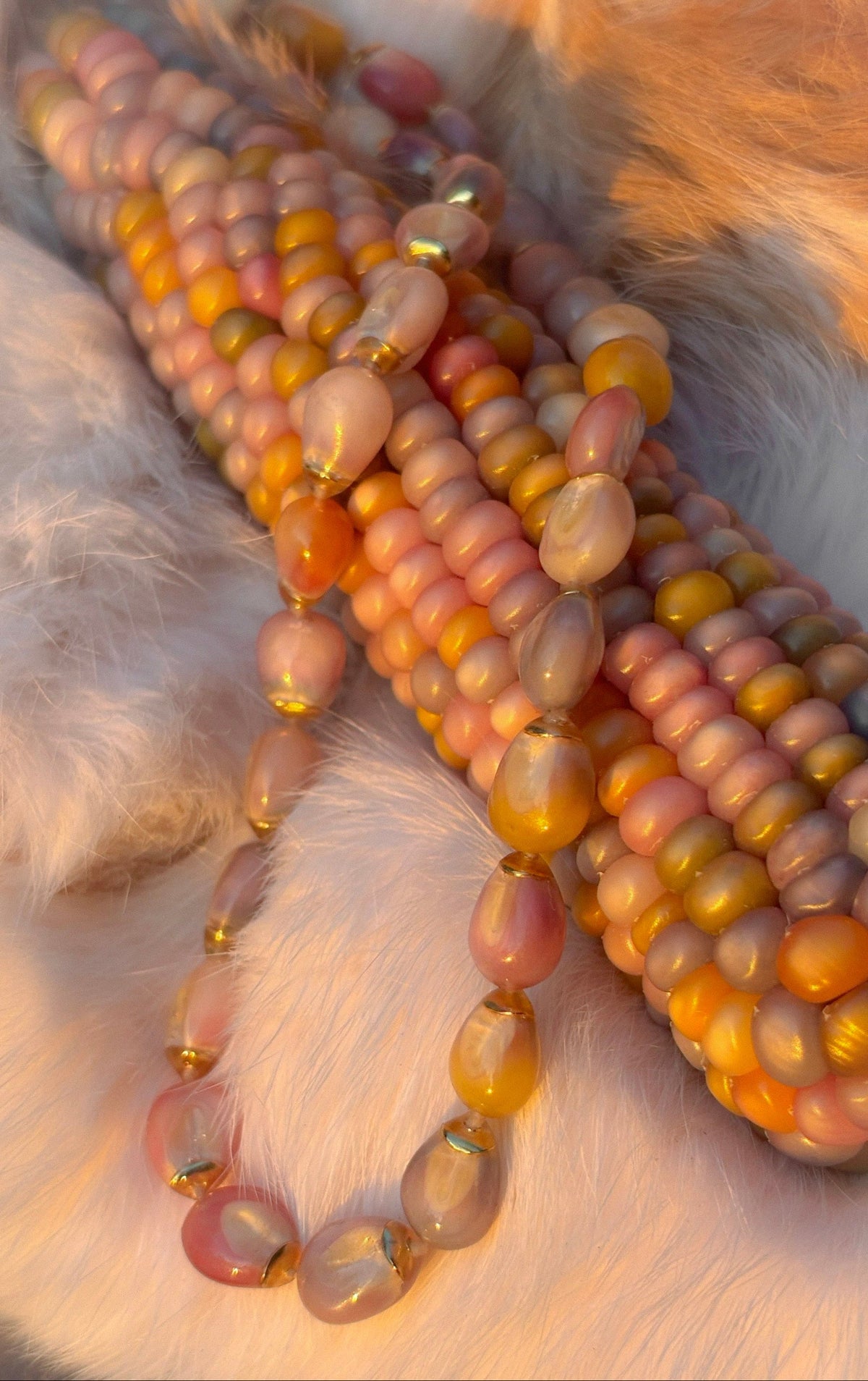 Glass Gem corn gem necklace draped over pastel corn cobs